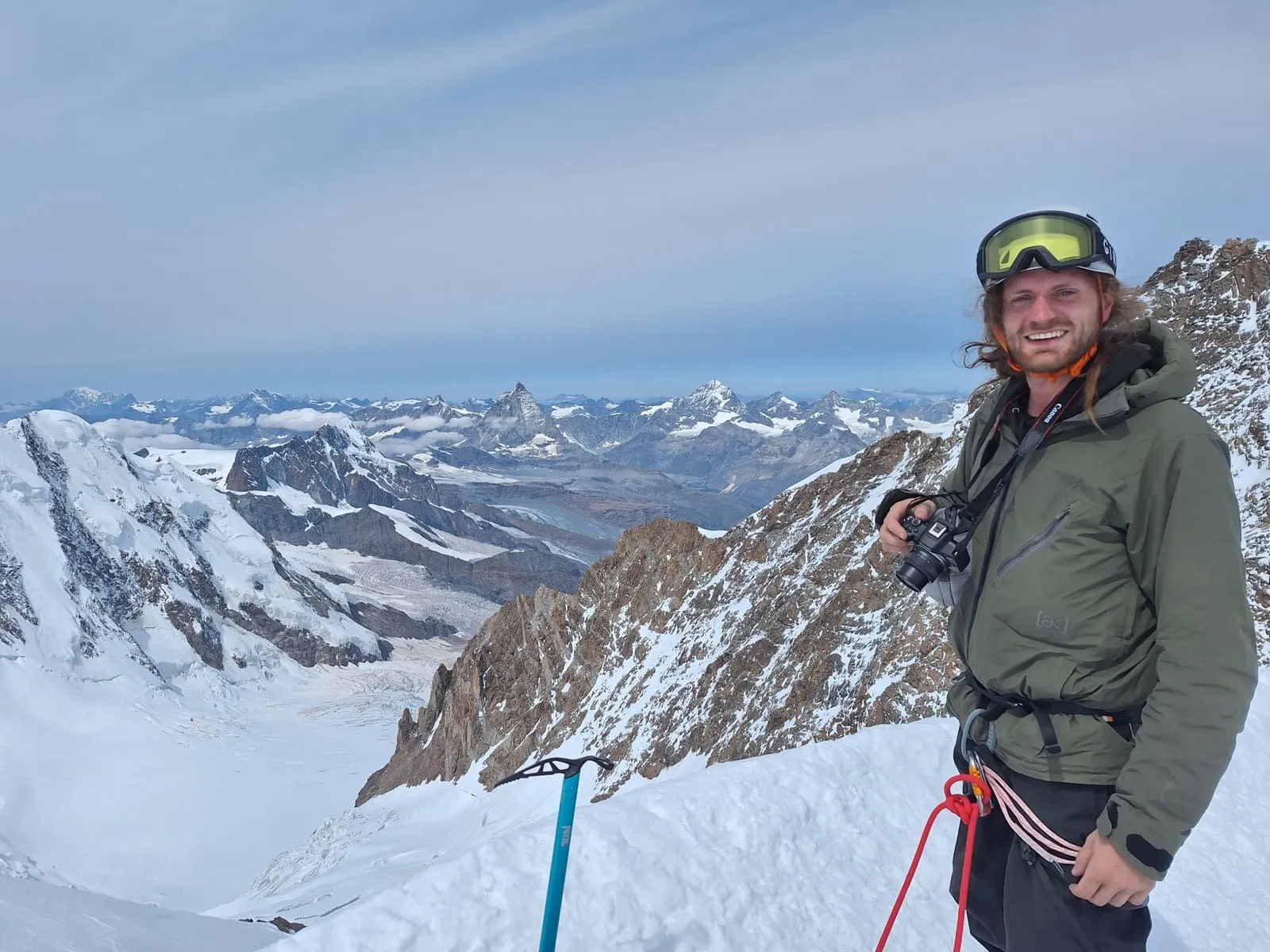 On a snowy summit ridge with the Matterhorn in the distance